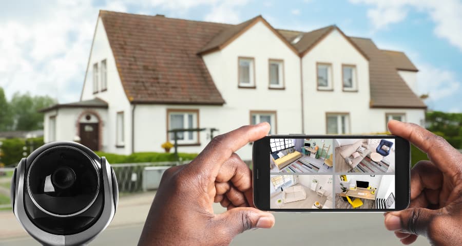Man holding smartphone and checking streams from security cameras