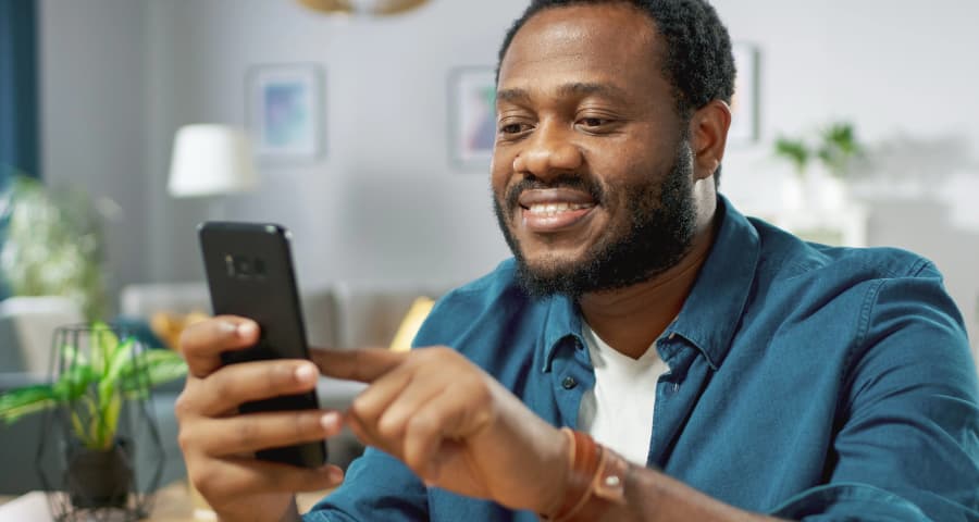 Man sitting down navigating an app on his phone